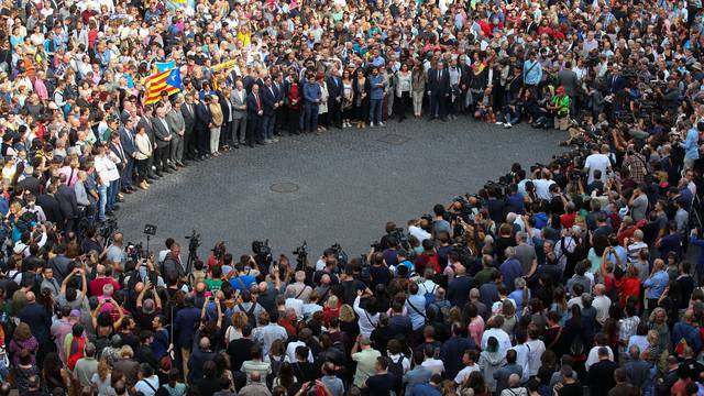 Catalan regional government members and local politicians stand in Plaza Sant Jaume as they join a protest called by pro-independence groups for citizens to gather at noon in front of city halls throughout Catalonia, in Barcelona