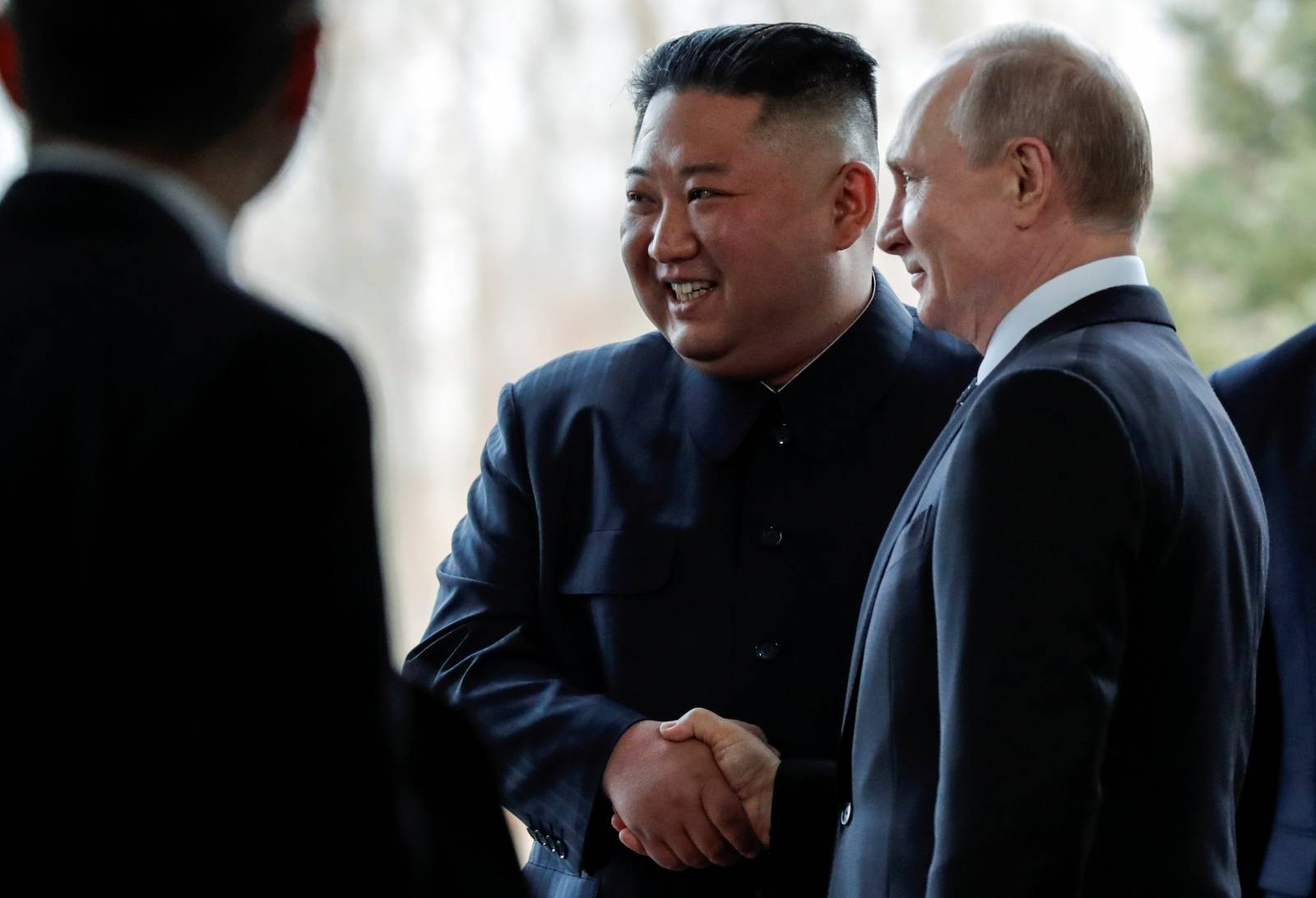 Russian President Vladimir Putin and North Korea's leader Kim Jong Un shake hands during their meeting in Vladivostok