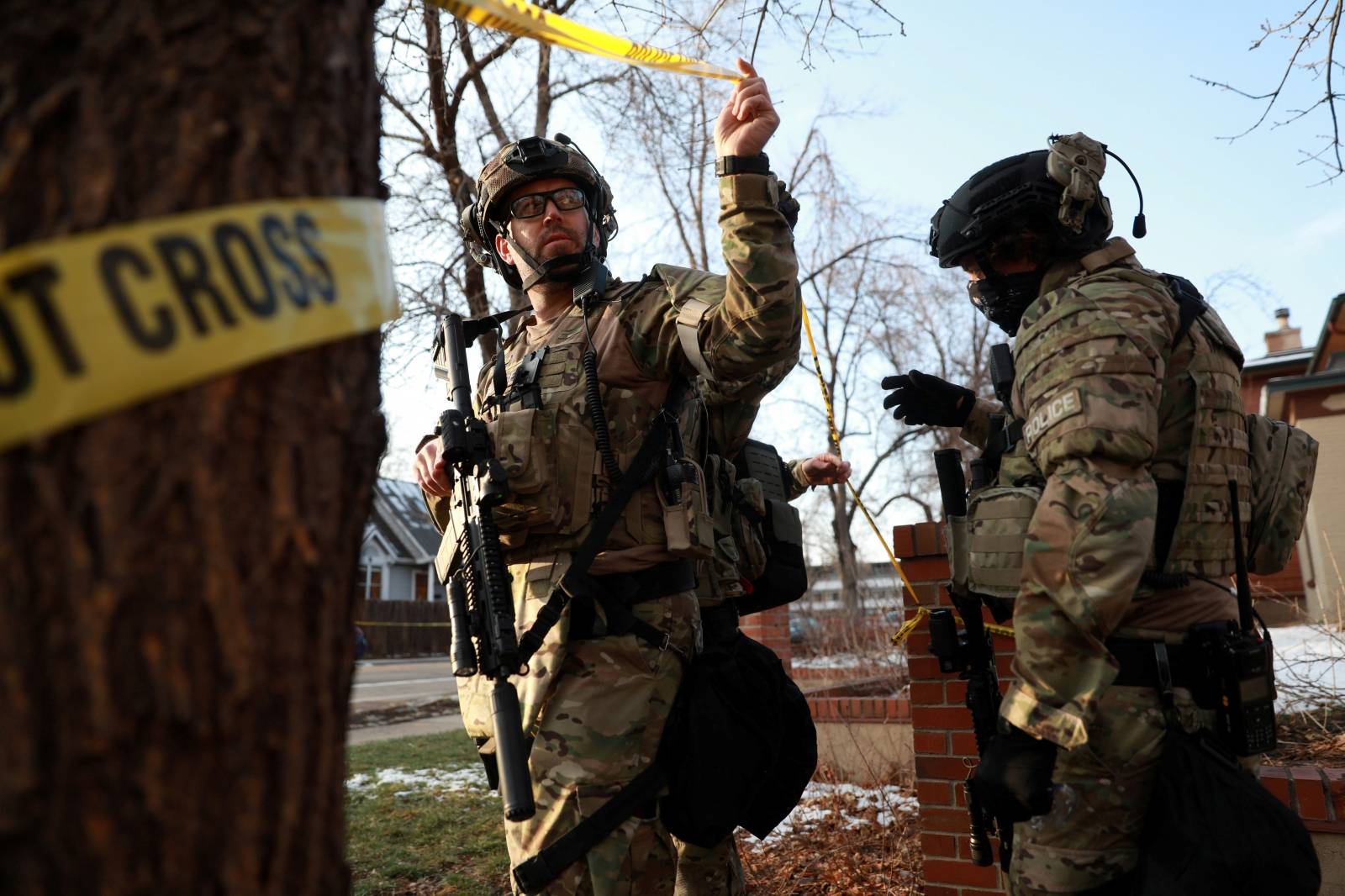 Law enforcement officers exit a home in Boulder as part of their investigation into a shooting at King Soopers grocery store, before leaving after finding no connection to the incident, in Boulder