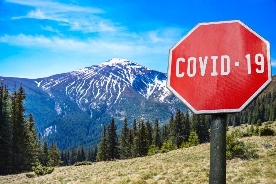 Mountains range with COVID-19 sign. Warning about global pandemic. Coronavirus disease. COVID-19 alert sign