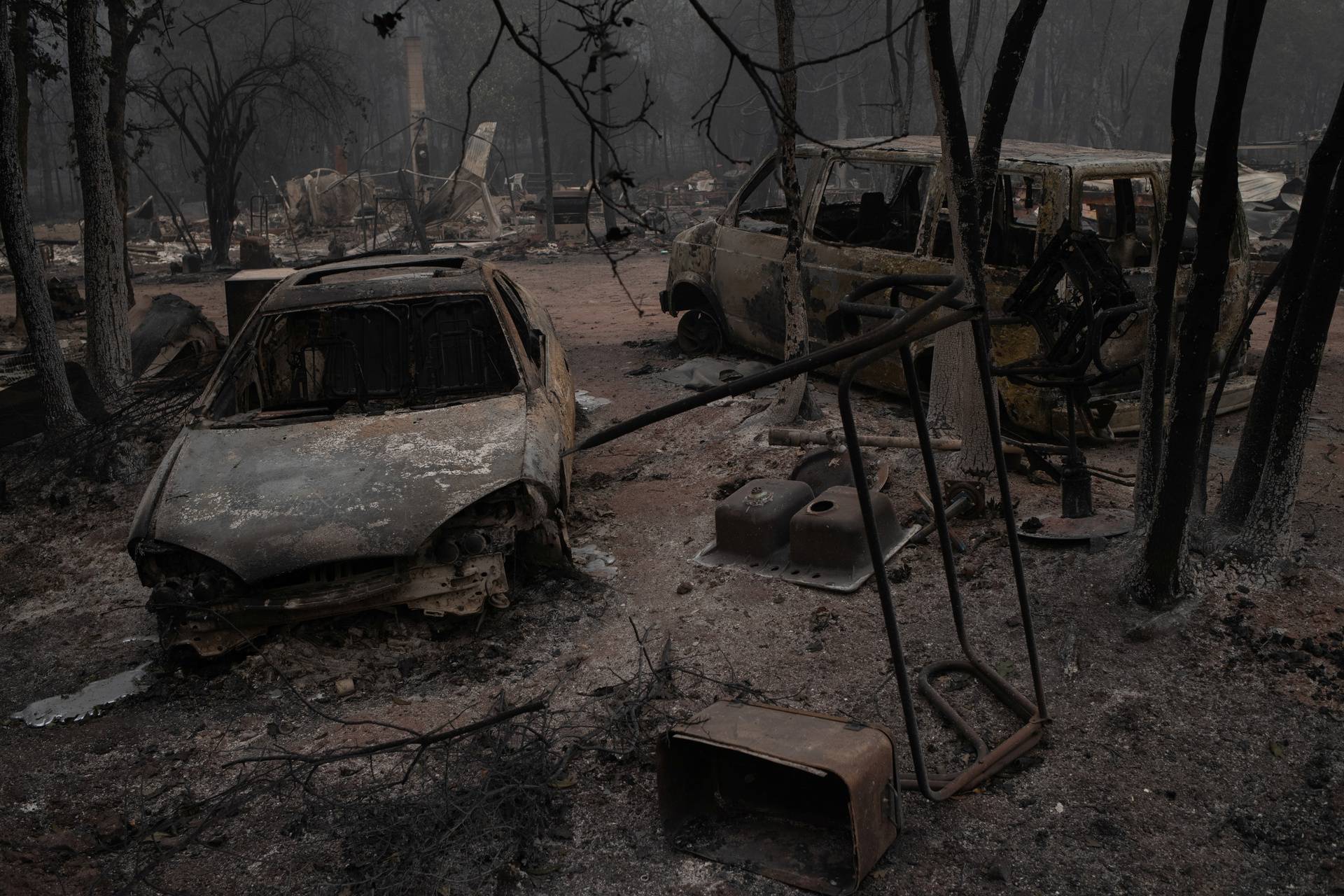 Vehicles lie damaged in the aftermath of the Obenchain Fire in Eagle Point, Oregon