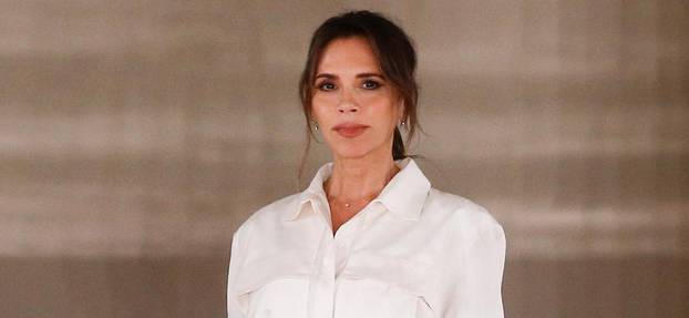 Designer Victoria Beckham at the end of her catwalk show during London Fashion Week in London