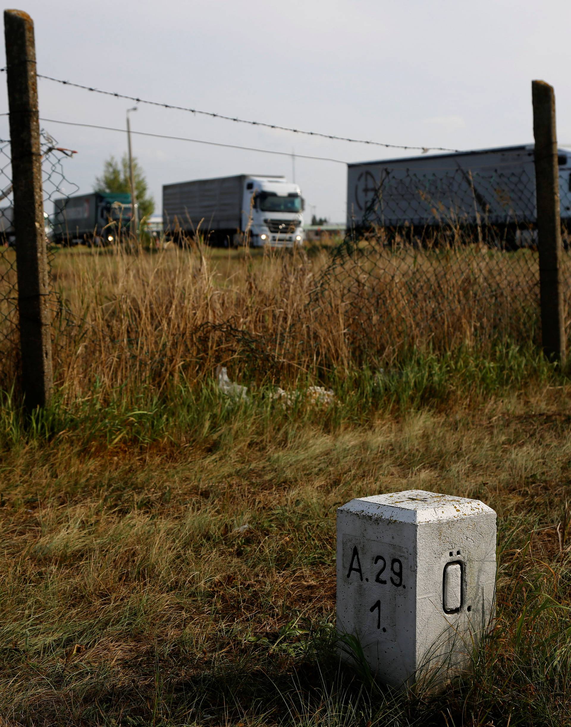 A fence and a border stone are seen at the Austrian-Hungarian border near Nickelsdorf