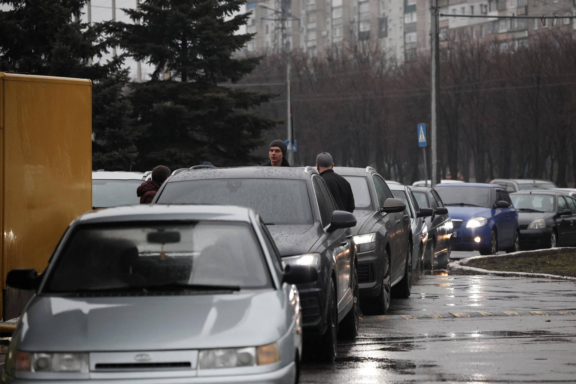 People in cars queue getting ready to leave the city, after Russian President Vladimir Putin authorized military operation in eastern Ukraine, in Mariupol