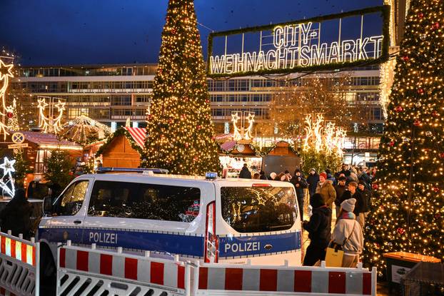 A police car secures an entrance of the Christmas market on the Breitscheidplatz, in Berlin