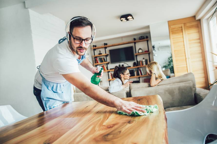 Husband housekeeping and cleaning concept. A man cleans the hous