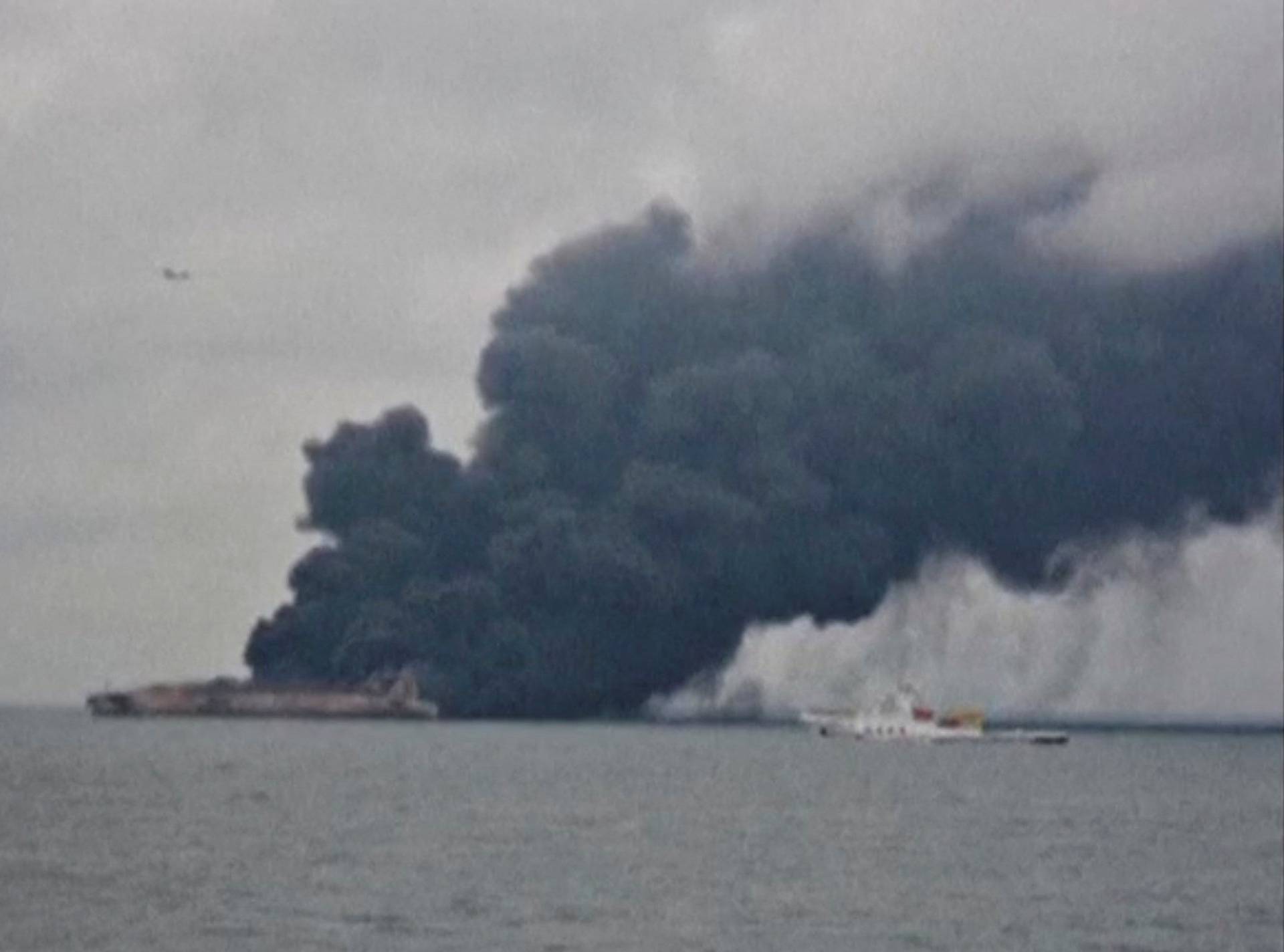 Smoke is seen from Panama-registered tanker Sanchi carrying Iranian oil after it collided with a Chinese freight ship in the East China Sea