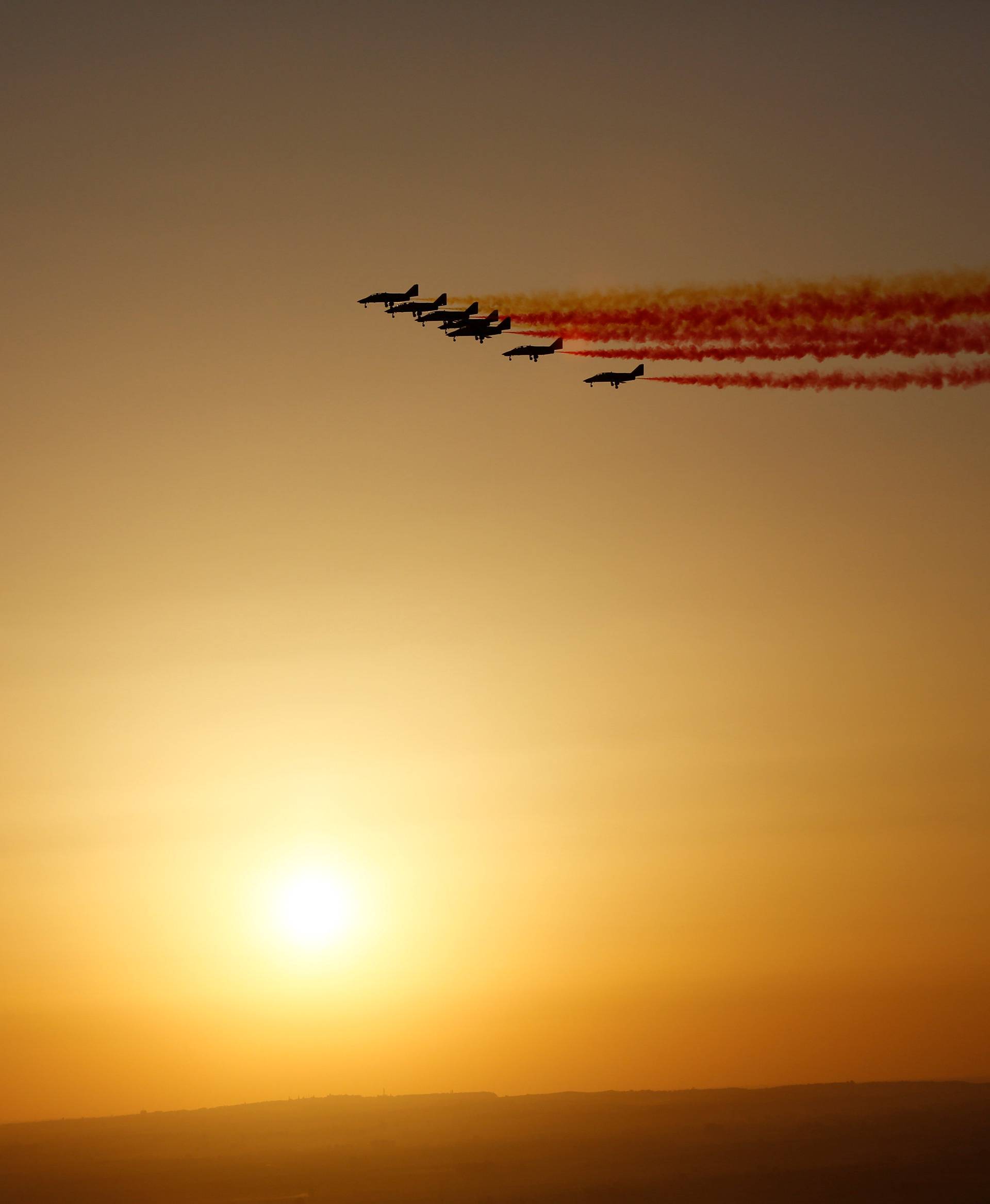 Spanish air force aerobatic team Patrulla Aguila fly for the event of the arrival of the solar-powered plane Solar Impulse 2 in Seville, southern Spain