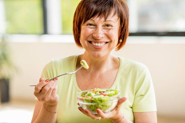 Older woman with healthy food indoors