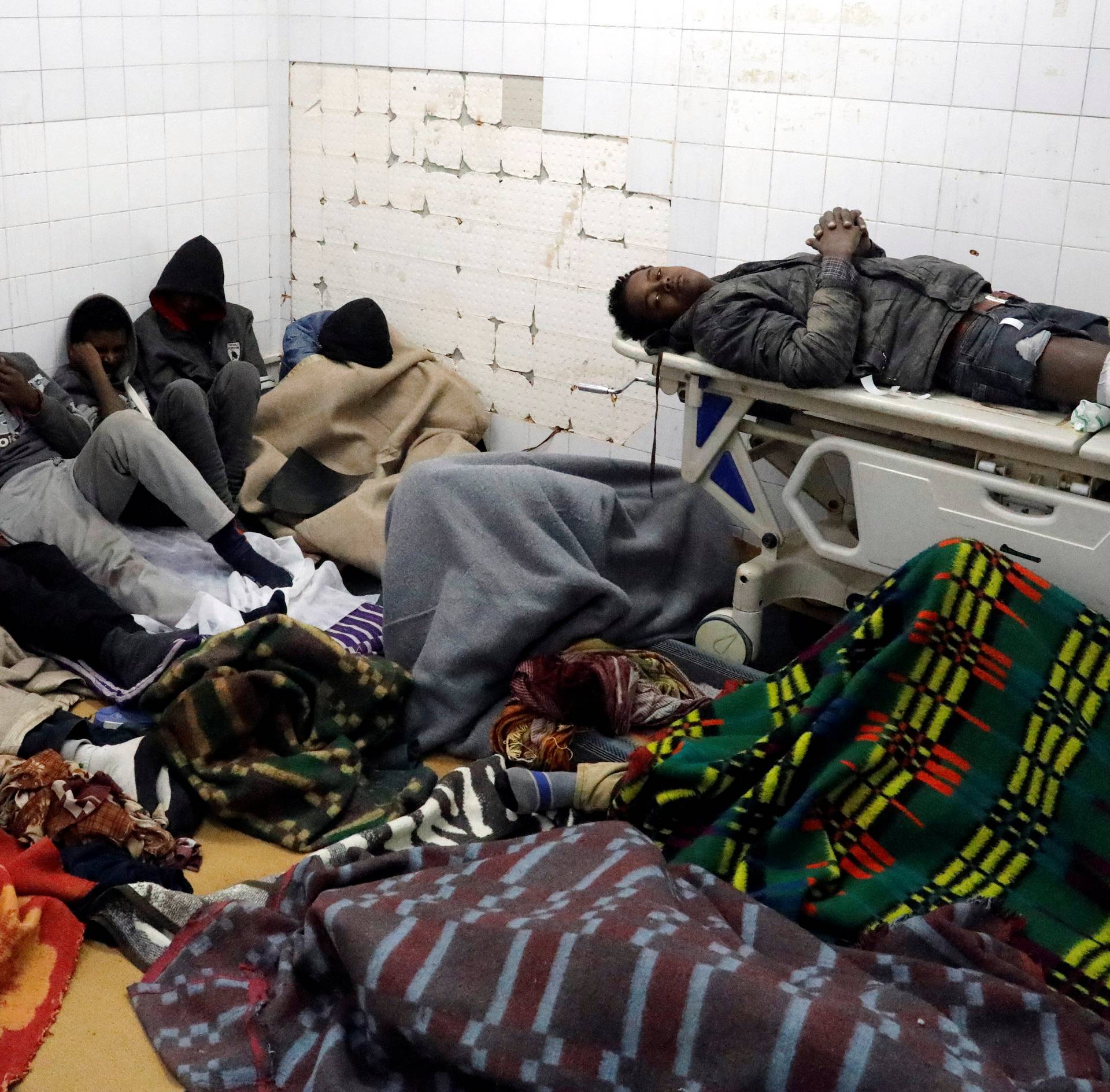 Migrants who were injured in a truck crash, are seen at a hospital in Bani Walid town