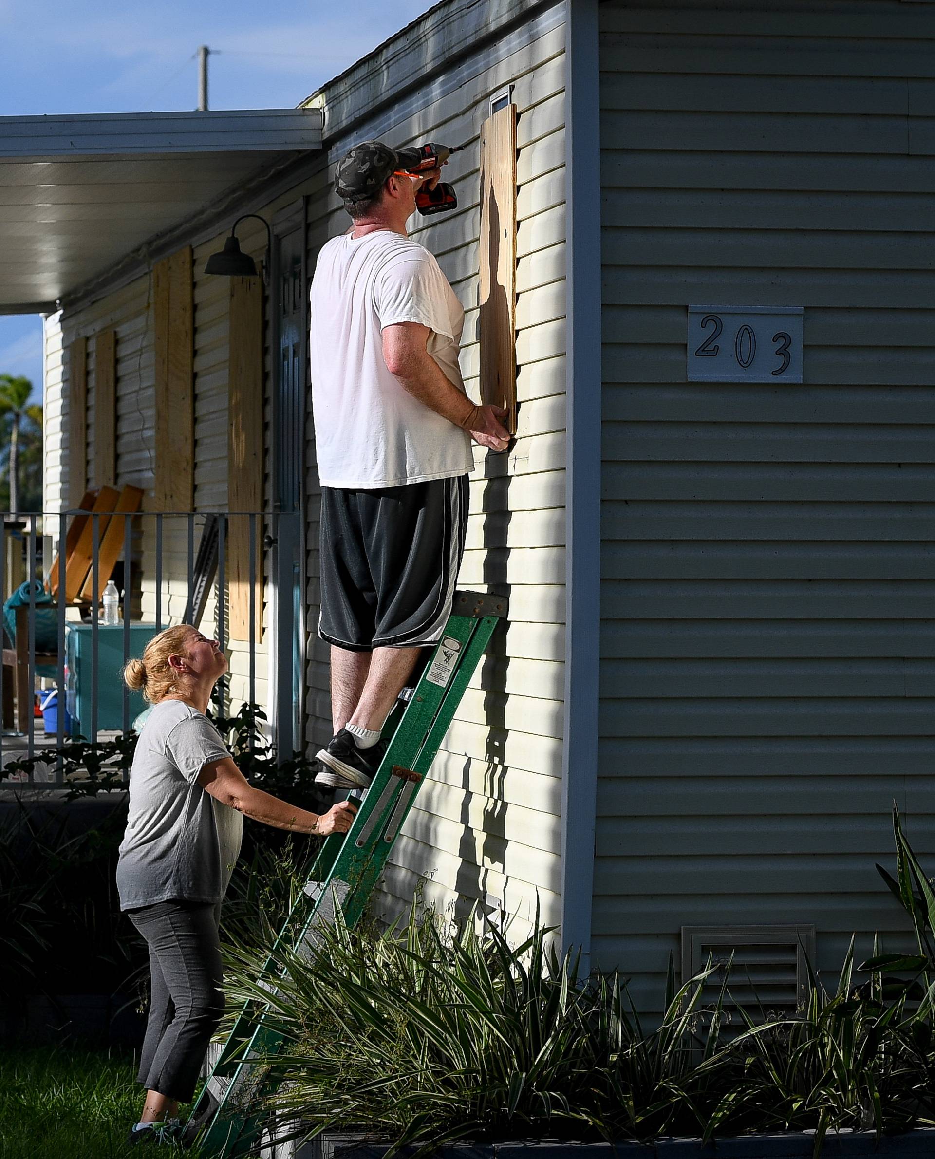 Yana and Jeremy Cauble board up their mobile home in preparation for Hurricane Irma in Homestead