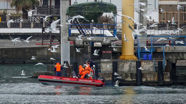 A boat of Russian Emergencies Ministry is seen near a pier, as rescue personnel conduct a search after a Russian military Tu-154 plane crashed into the Black Sea on its way to Syria on Sunday, in the Black Sea resort city of Sochi