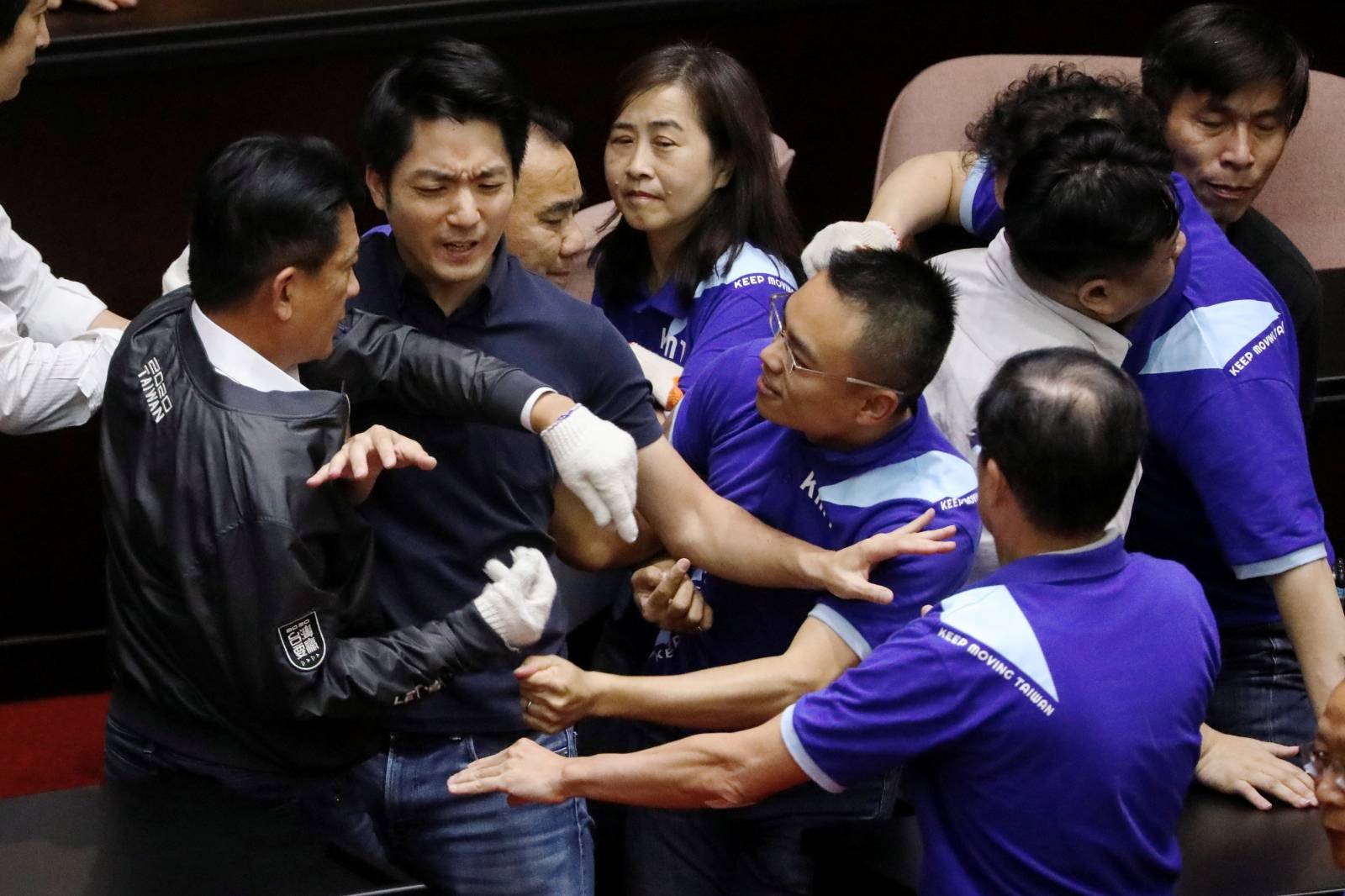 Lawmakers from Taiwan's ruling Democratic Progressive Party (DPP) scuffle with lawmakers from the main opposition Kuomintang (KMT) party, who have been occupying the Legislature Yuan, in Taipei
