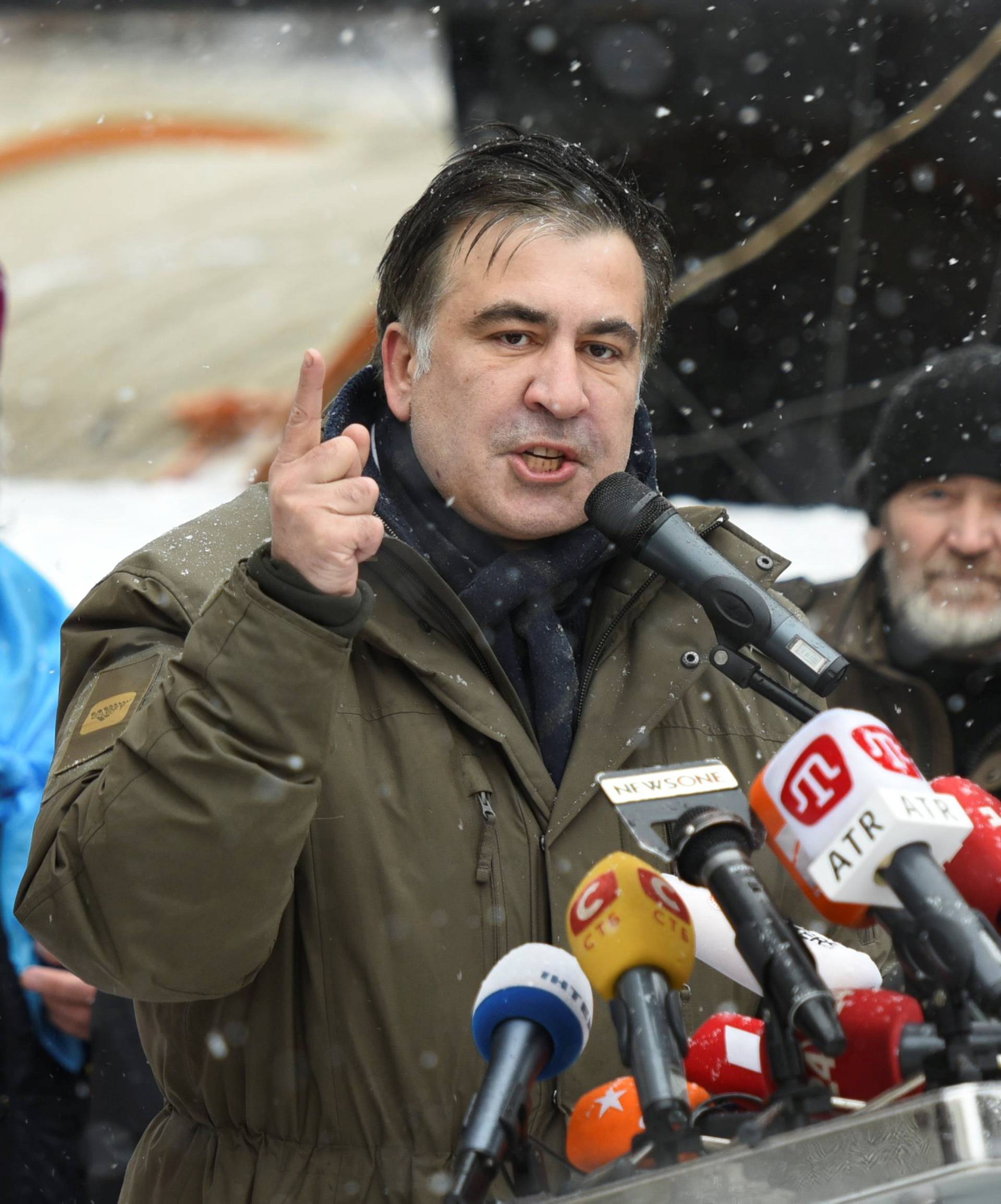Former Georgian President Mikheil Saakashvili, accompanied by his wife Sandra Roelofs, addresses his supporters in front of the Parliament building in Kiev