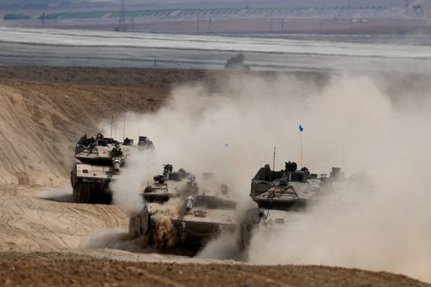 Israeli tanks manoeuvre near the Israel-Gaza border, in southern Israel