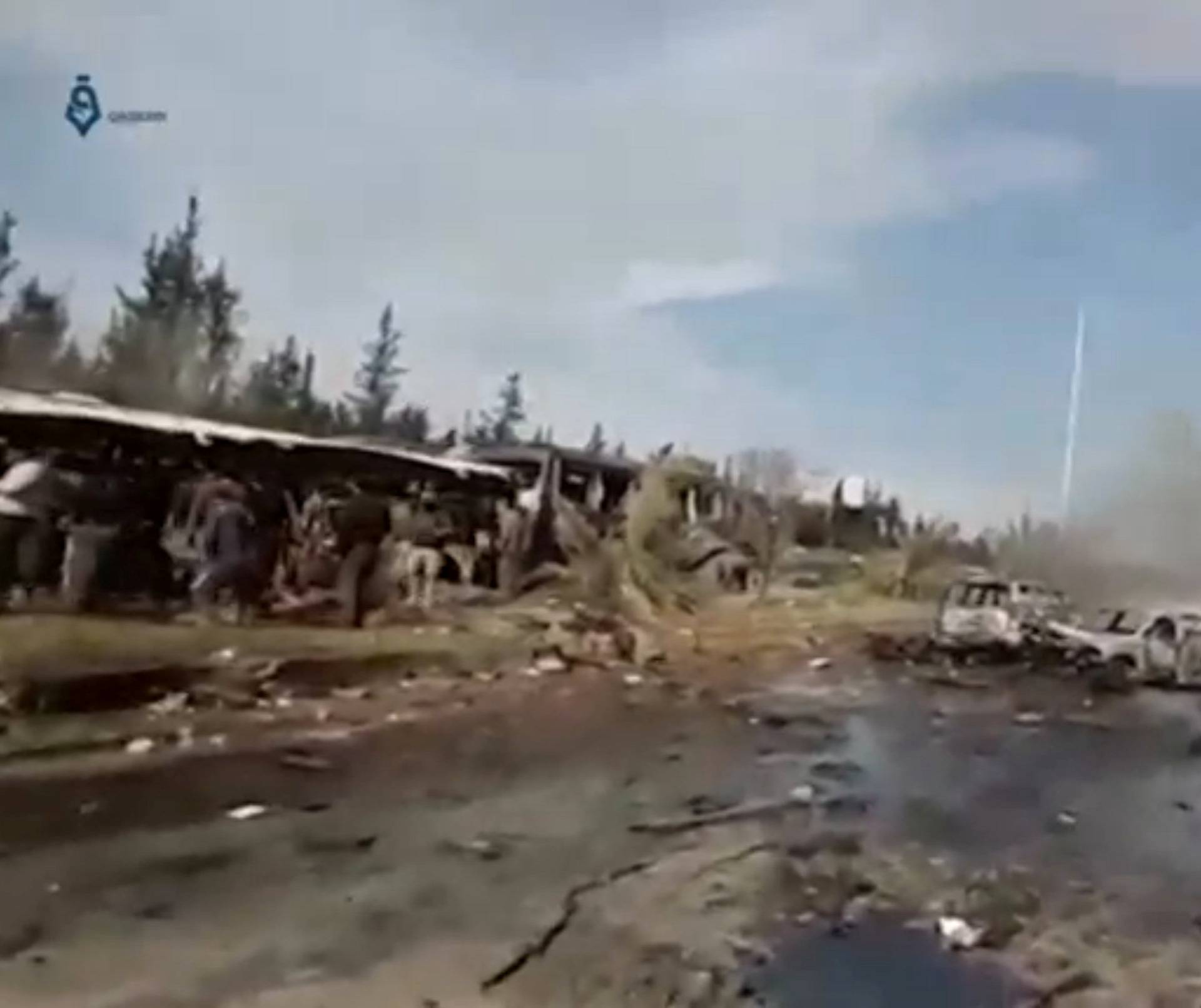 A still image taken from a video uploaded on social media on April 15, 2017, shows burnt out buses on road, scattered debris lying nearby and injured people being tended to away from buses said to be in Aleppo