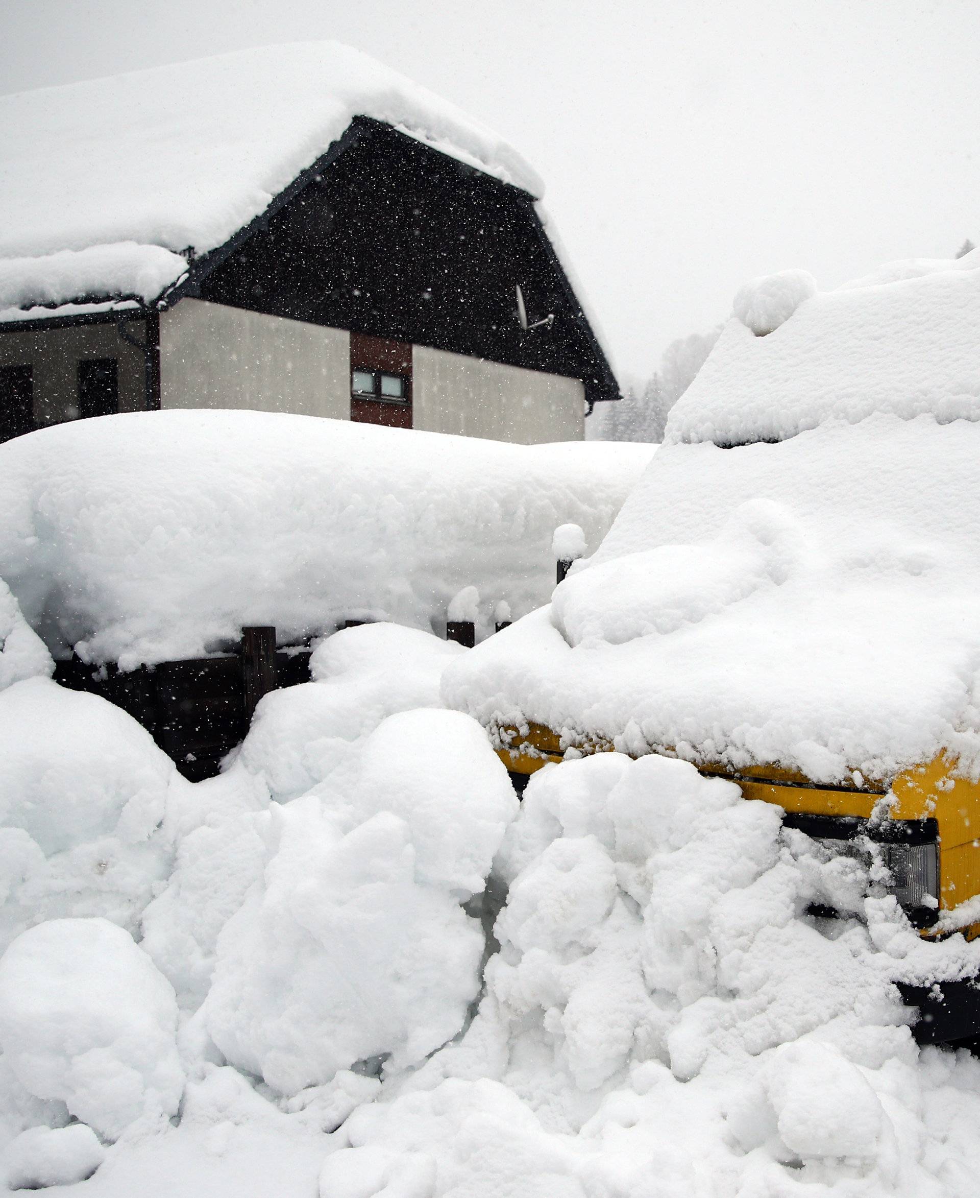 A parked car is covered with snow in Goestling