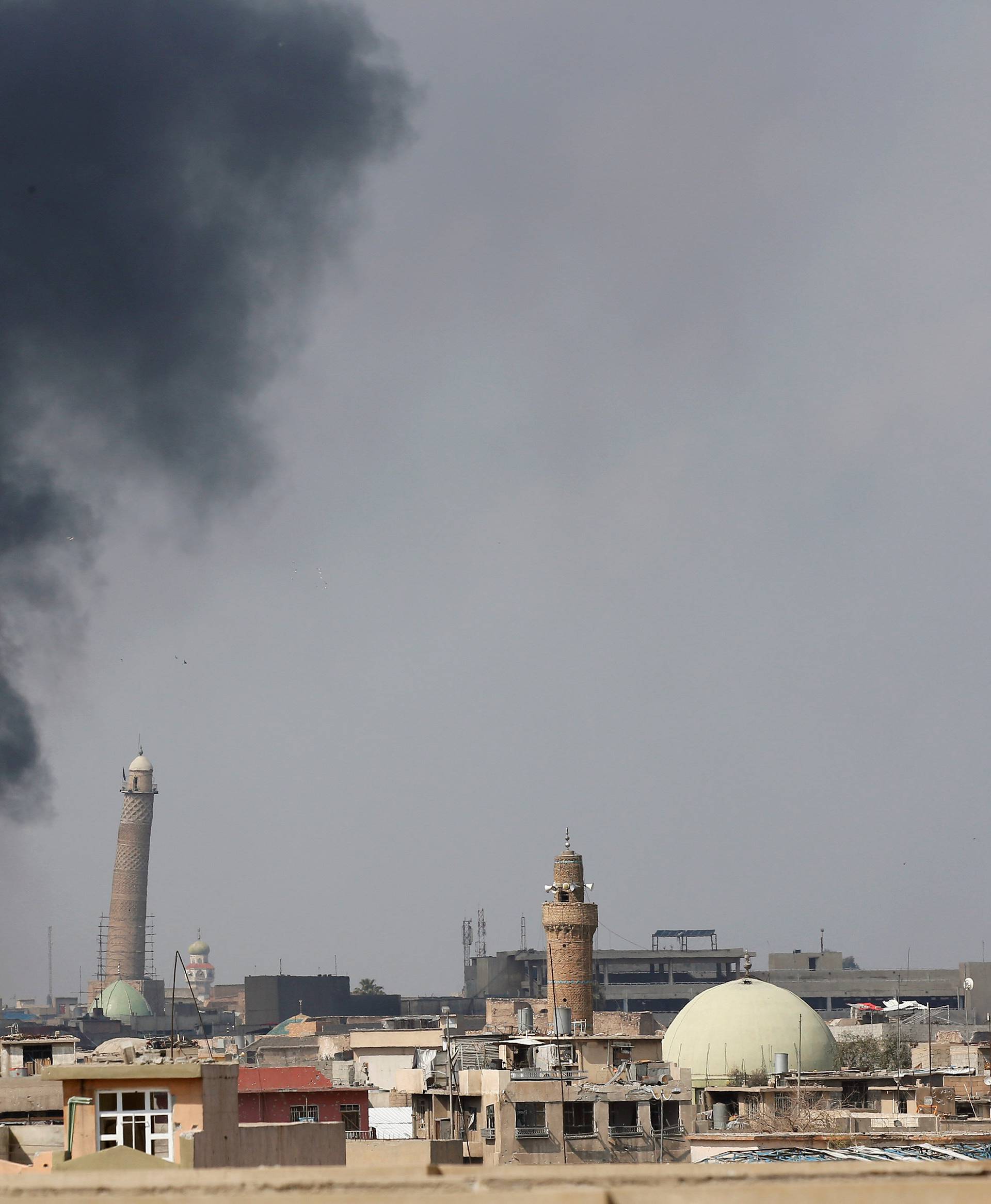FILE PHOTO: Smoke rises from clashes near Mosul's Al-Habda minaret at the Grand Mosque, where Islamic State leader Abu Bakr al-Baghdadi declared his caliphate back in 2014, in Mosul