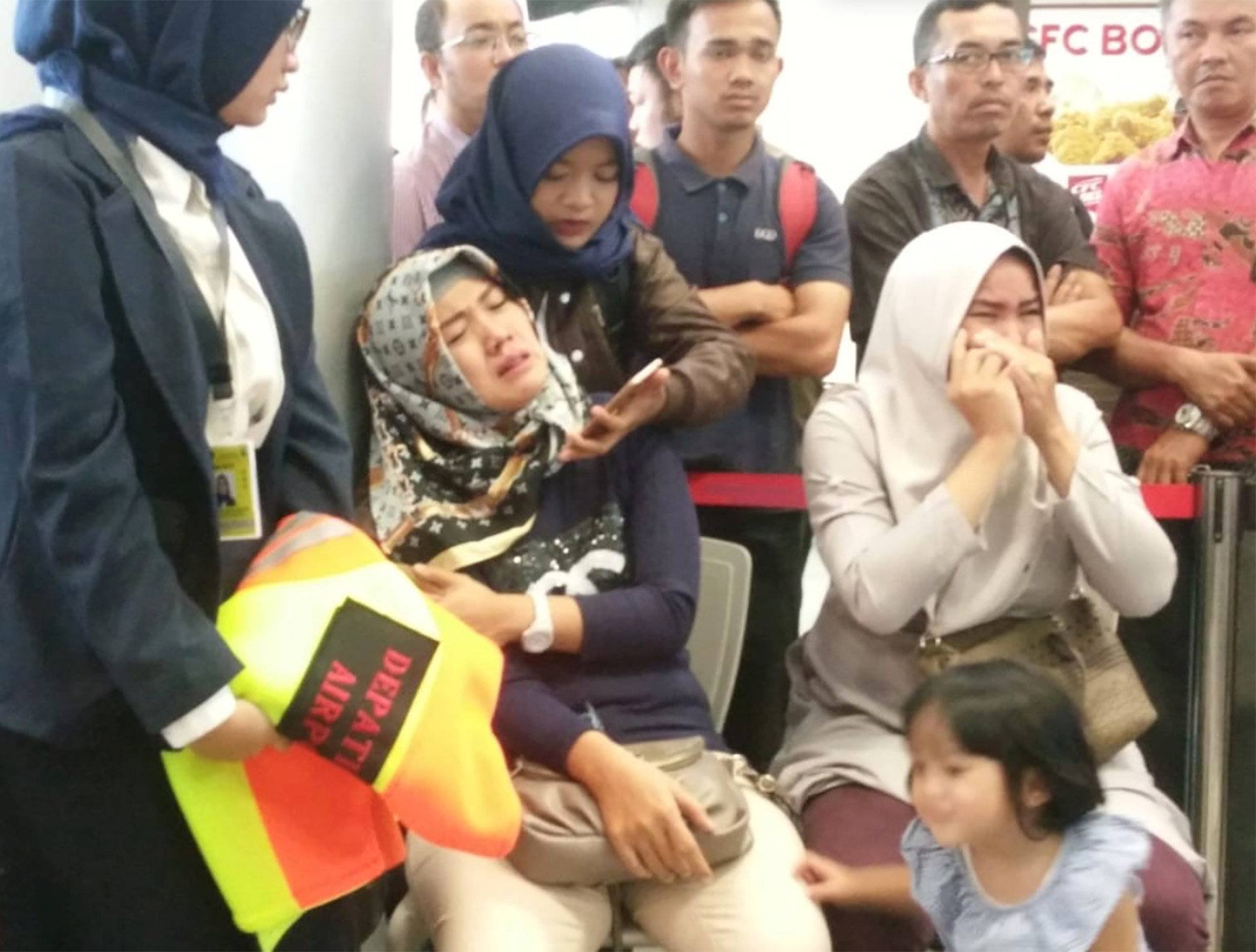 Relatives of passengers of Lion Air flight JT610 that crashed into the sea, cry at Depati Amir airport in Pangkal Pinang