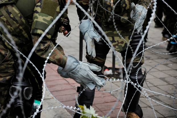 Polish Kosovo Force (KFOR) puts up a barbed wire near a municipal office in Zvecan