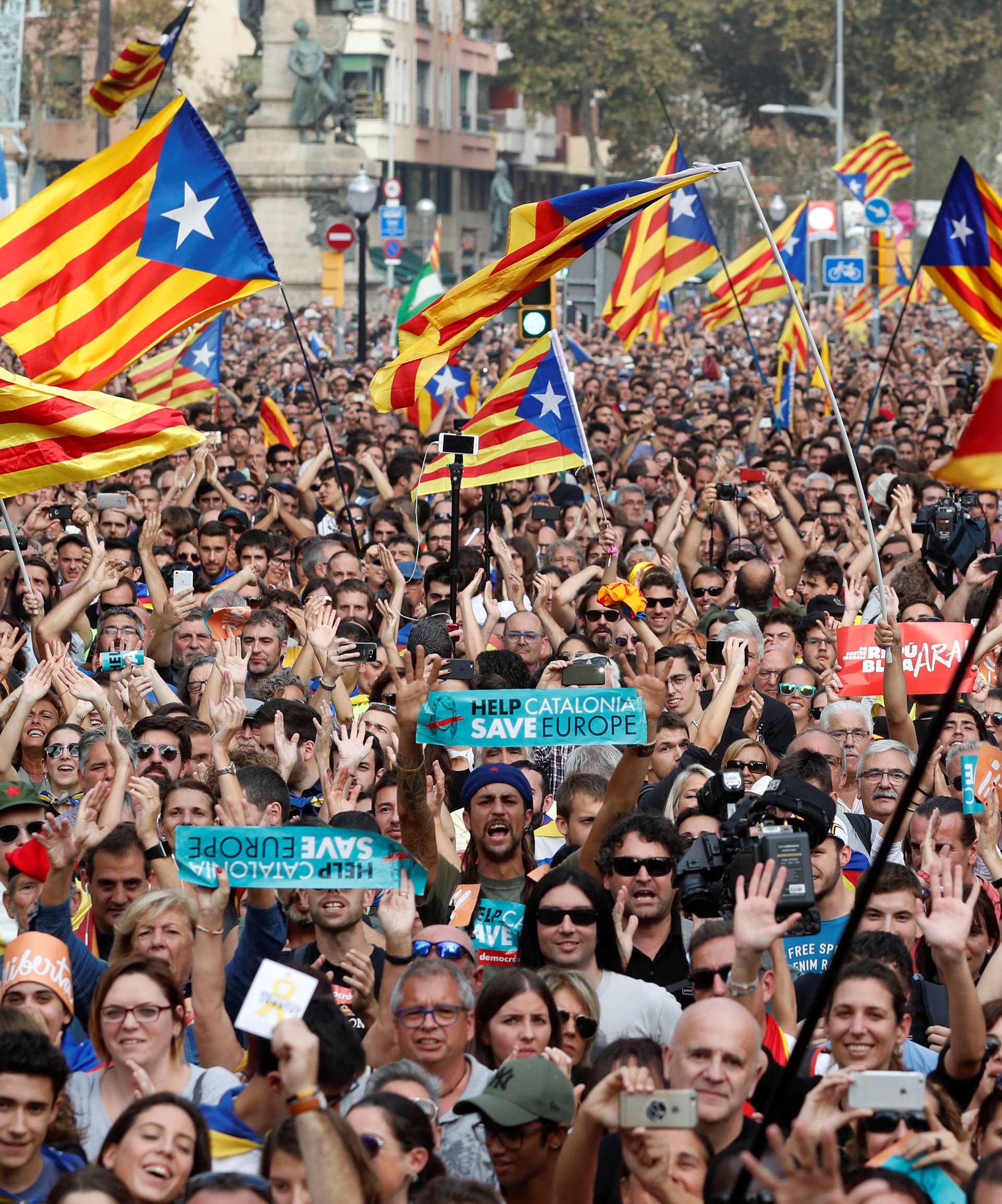 People react while the Catalan regional parliament votes for independence of Catalonia from Spain in Barcelona