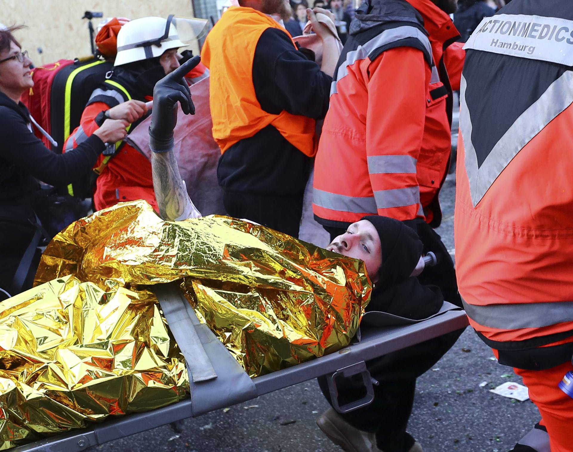 An injured protester is stretchered away during anti G-20 riots in Hamburg