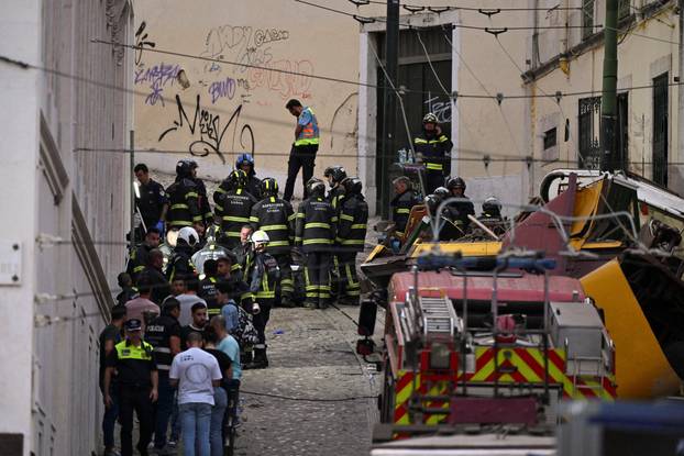 First responders work at the site of a funicular accident in Lisbon