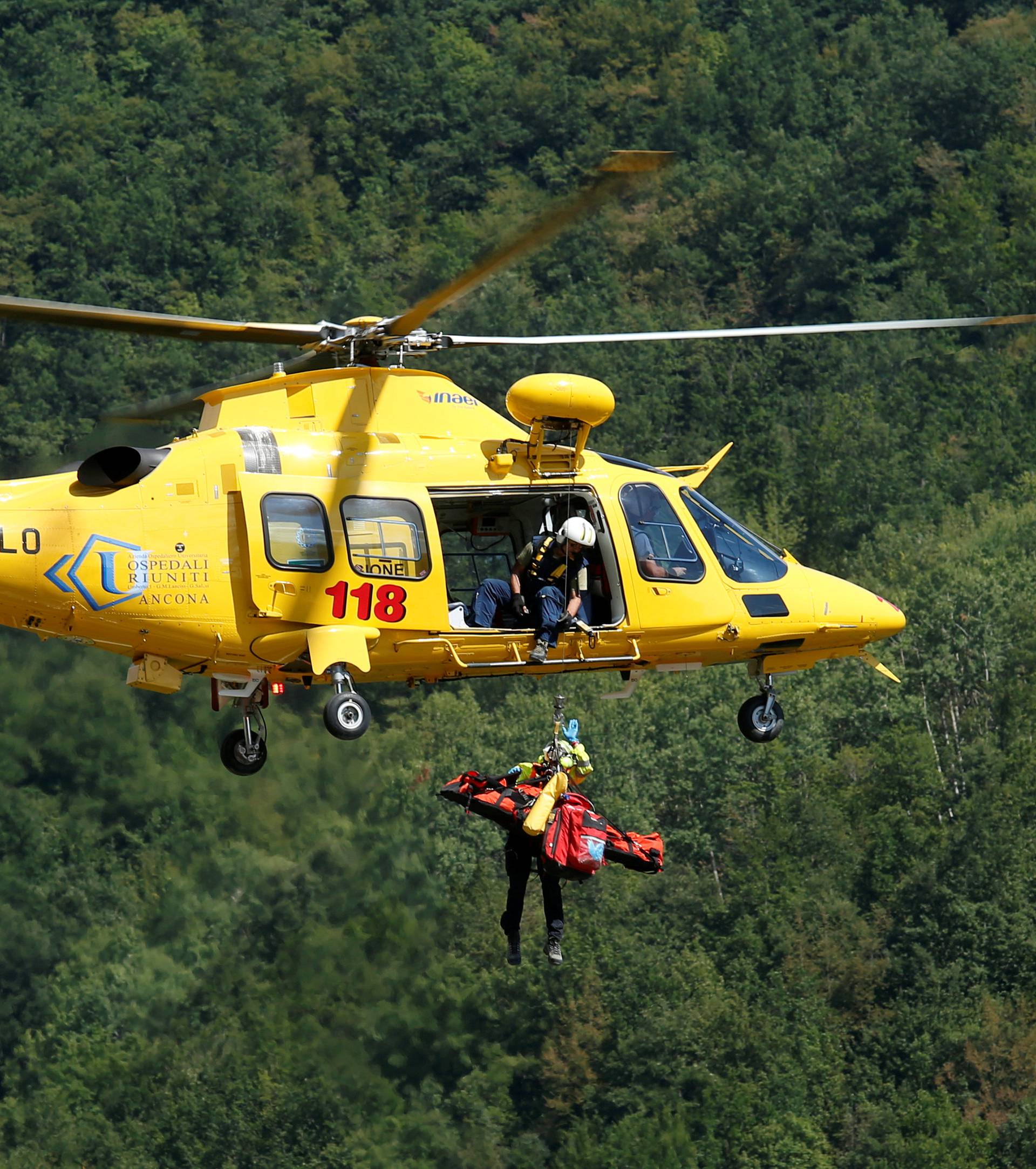 An injured person is rescued with a helicopter following an earthquake at Pescara del Tronto
