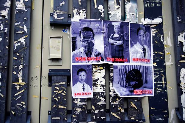 Posters in memory of late doctor Li Wenliang and other doctors are seen on a street near the Central Hospital of Wuhan