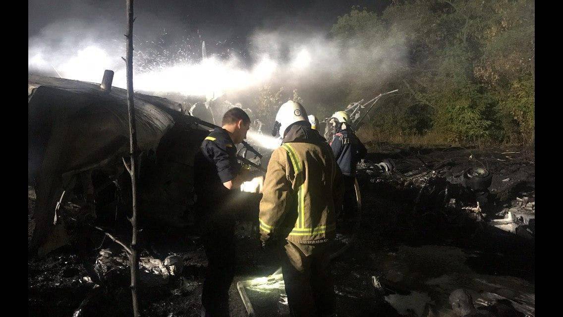 Rescuers work at the crash site of the Ukrainian military Antonov An-26 plane outside of Chuhuiv town