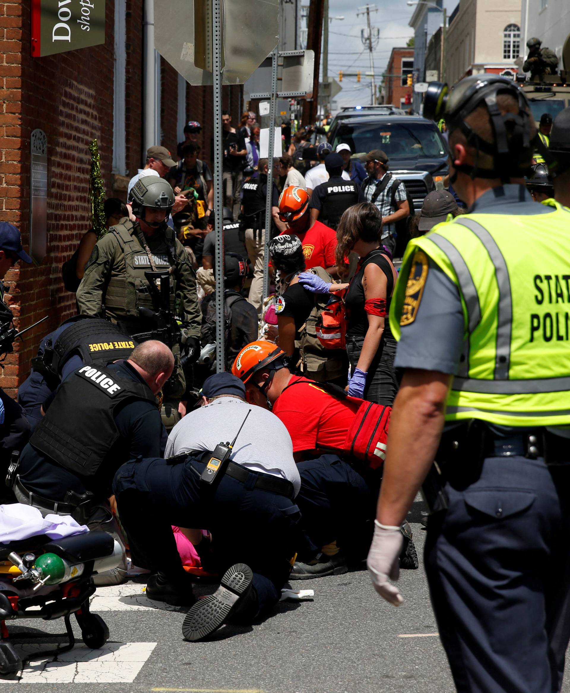Rescue workers assist people who were injured when a car drove through a group of counter protestors at the "Unite the Right" rally in Charlottesville