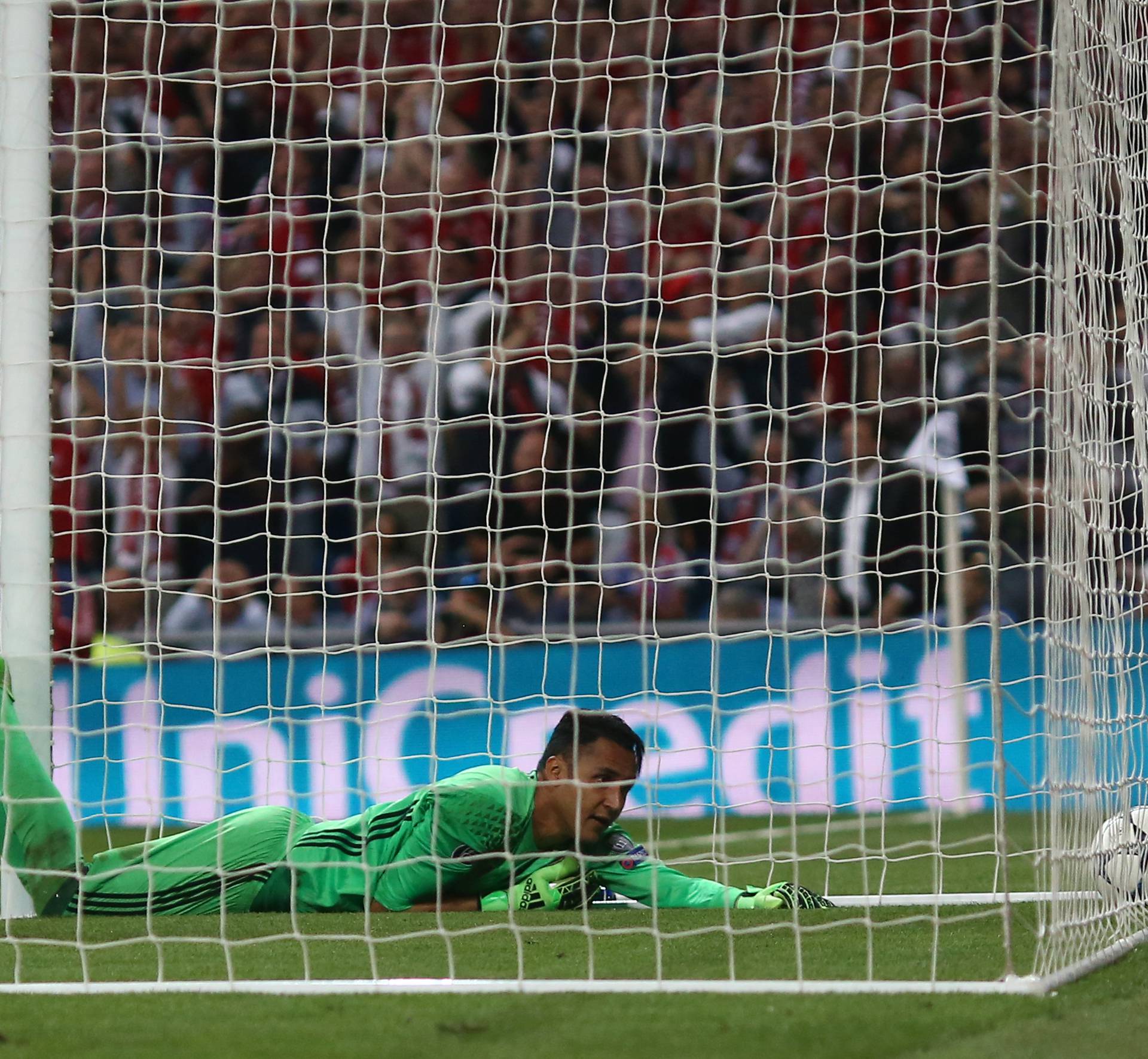 Real Madrid's Keylor Navas looks dejected after Sergio Ramos scores an own goal and the second goal for Bayern Munich