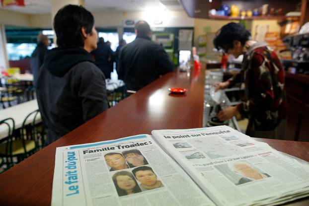 A newspaper sits on the counter of a neighborhood bar near the house of the Troadec family in Orvault