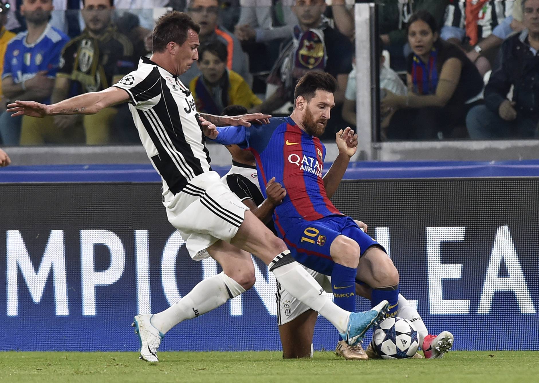 Barcelona's Lionel Messi in action with Juventus' Mario Mandzukic