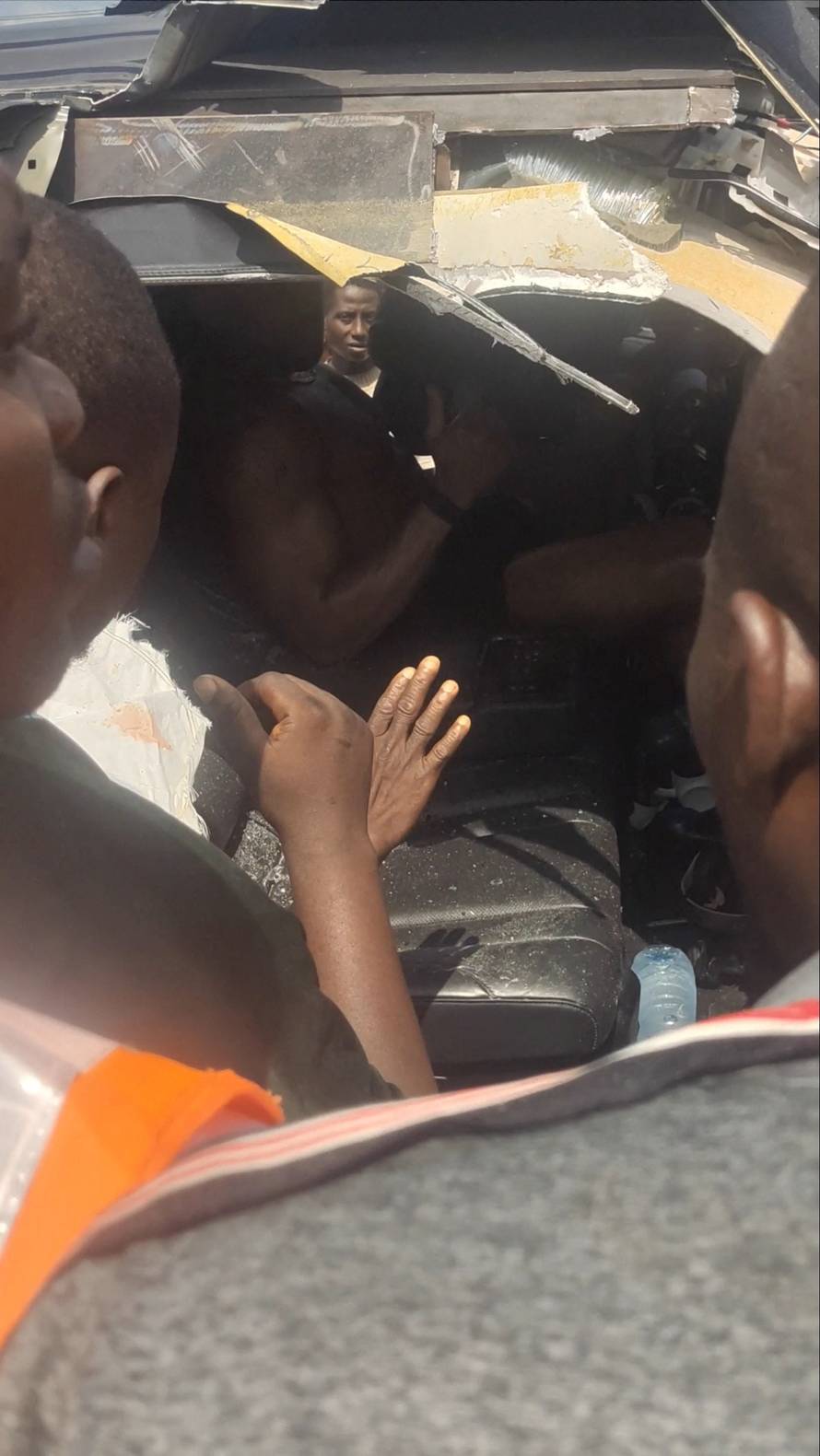 Former heavyweight boxing champion Anthony Joshua gestures from inside a vehicle following a car accident, near Sagamu