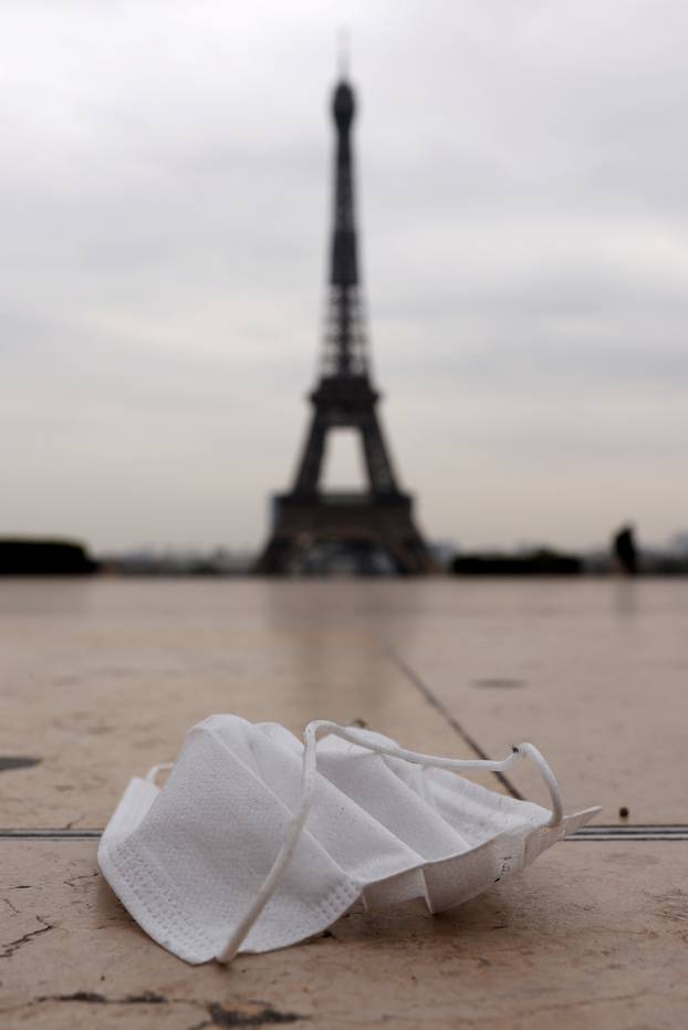 FILE PHOTO: A protective face mask is seen on the pavement at the deserted Trocadero square near the Eiffel tower in Paris