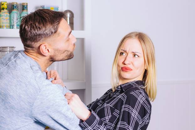 Couple problems concept. Attractive young woman refuses the kiss
