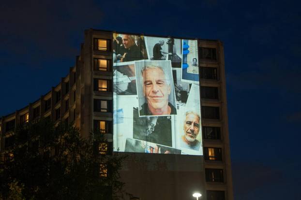 Documents and photos of Jeffrey Epstein and U.S. President Trump projected onto Hilton ahead of WHCA Gala, in Washington, D.C.