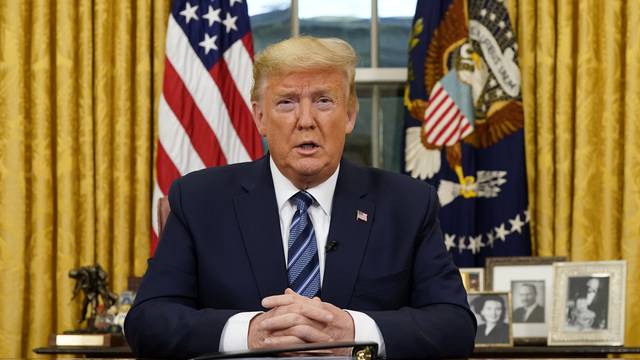 U.S. President Trump speaks about the U.S response to the COVID-19 coronavirus pandemic during an address to the nation from the Oval Office of the White House