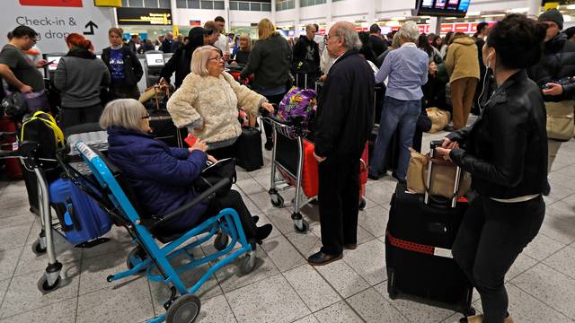 Passengers wait around in the South Terminal building at Gatwick Airport after drones flying illegally over the airfield forced the closure of the airport, in Gatwick