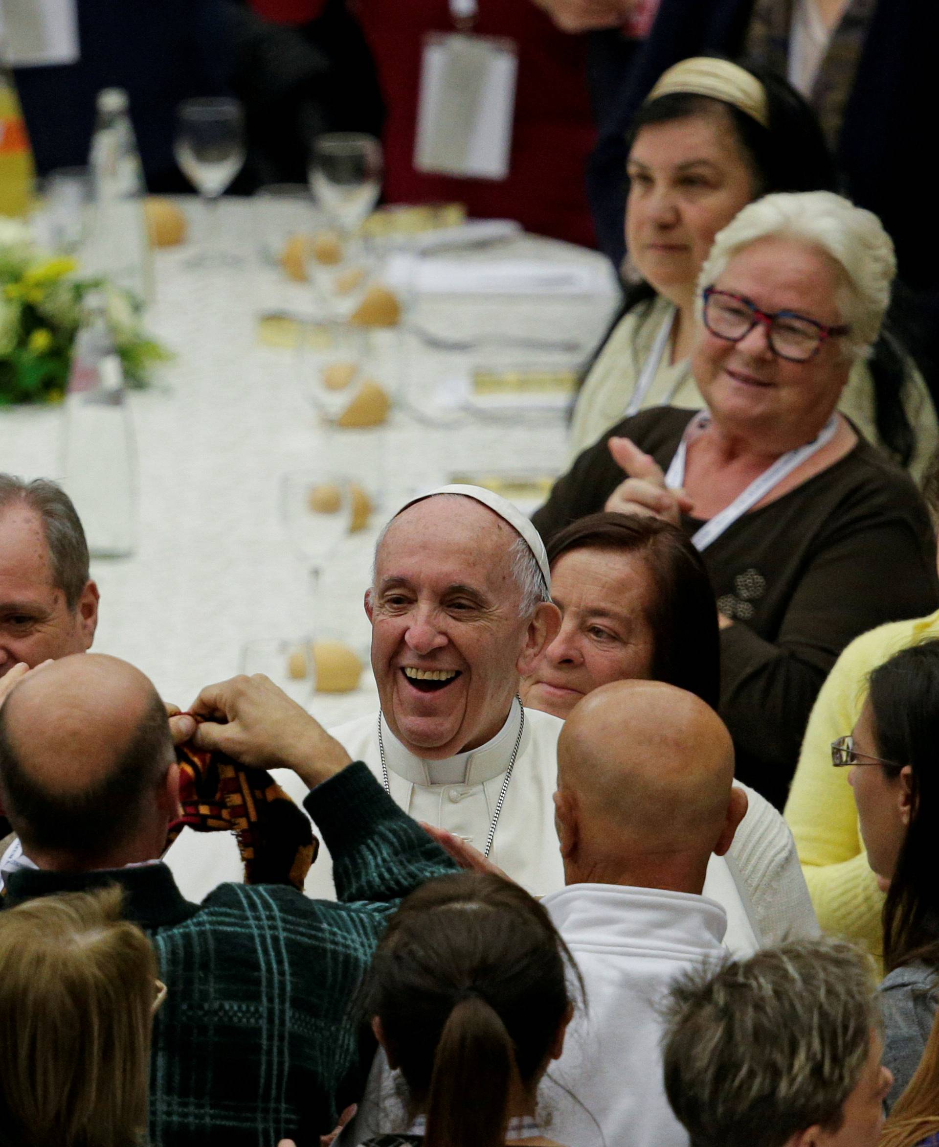 Pope Francis smiles before sharing a lunch with the poor following a special mass to mark the new World Day of the Poor in Paul VI's hall at the Vatican