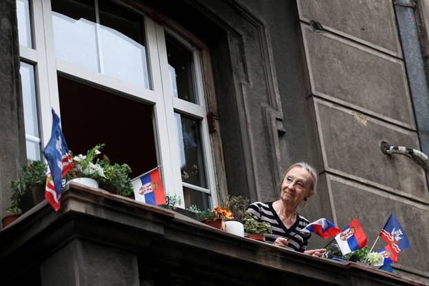 People attend a rally in support of policies of the President Aleksandar Vucic