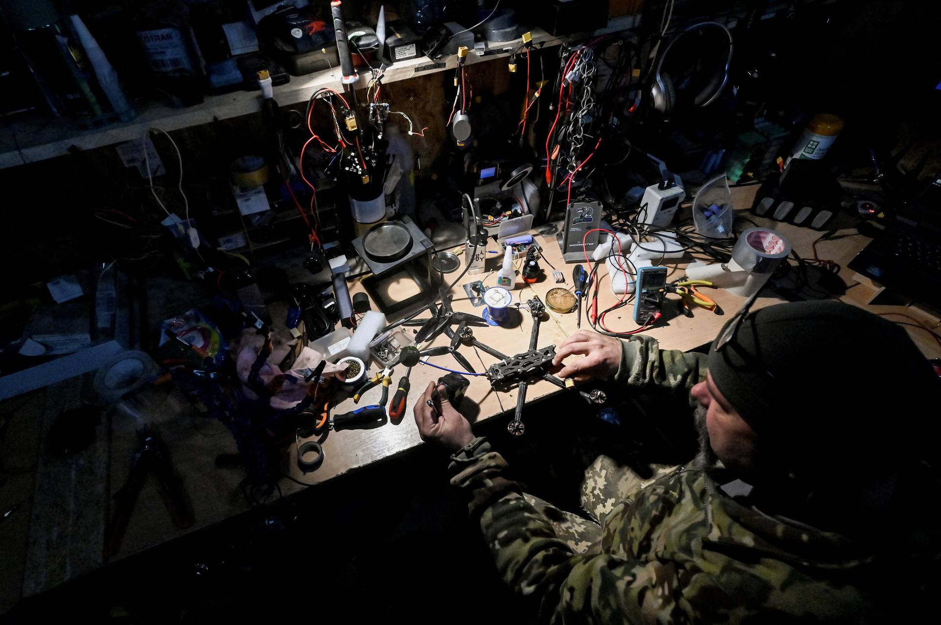 Ukrainian serviceman works with FPV drones at a workshop at their position near a frontline in Zaporizhzhia region