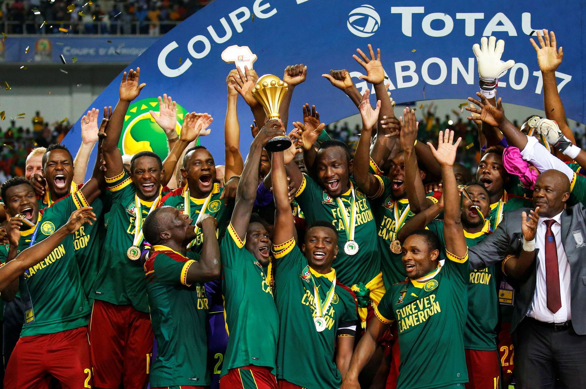 FILE PHOTO: Cameroon's Benjamin Moukandjo celebrates with the trophy and teammates after winning the African Cup of Nations