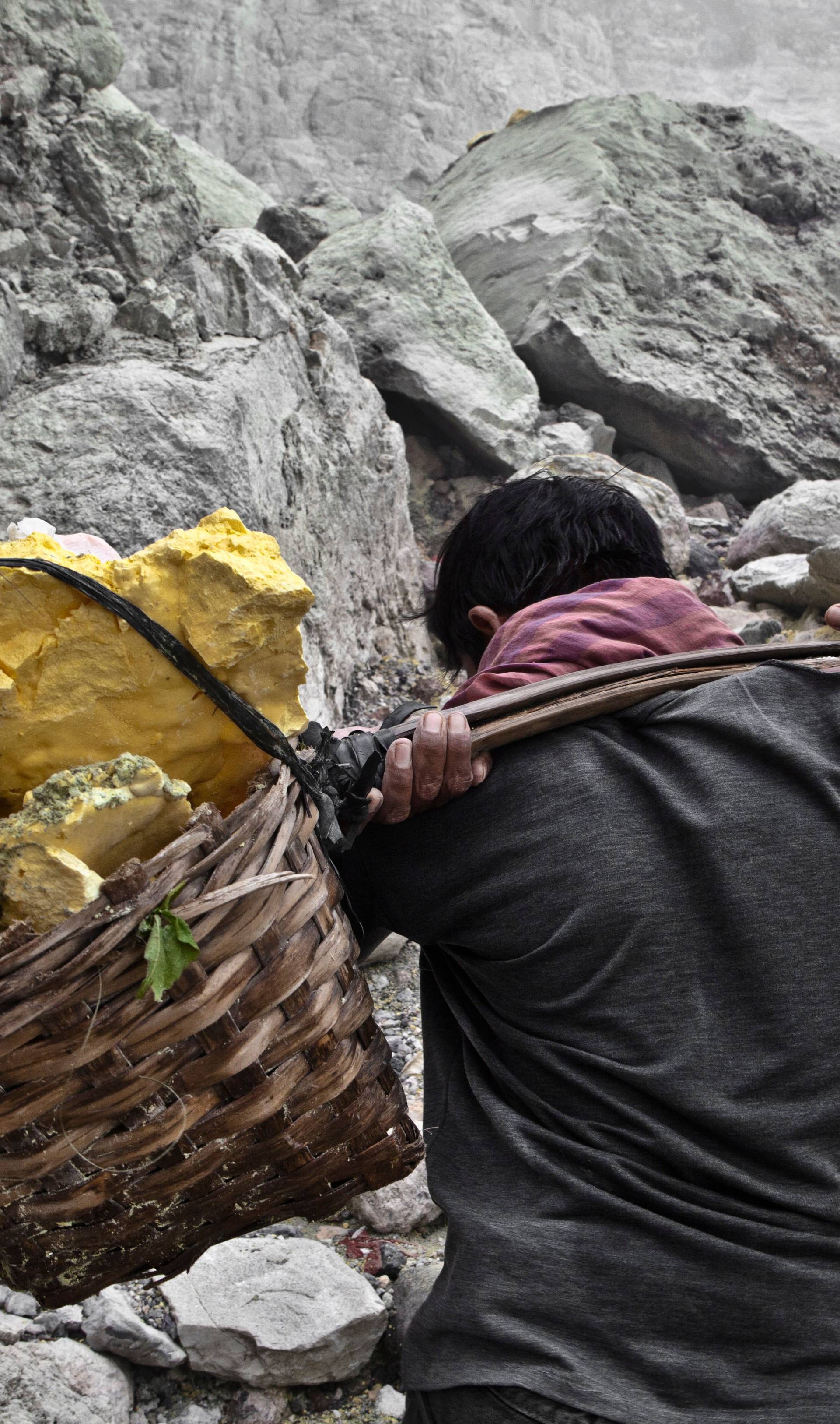 Sulfur workers at Kawa Ijen volcano in the sulfur mine, Kawa Ijen Plateau East Java Indonesia, Pacif