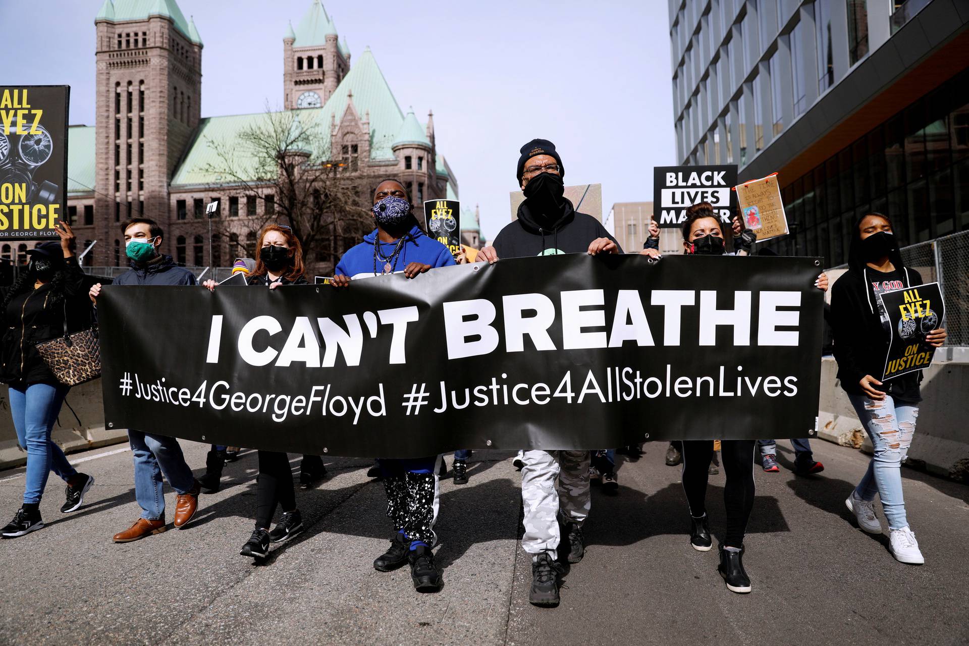 FILE PHOTO: Protesters and activists march during a vigil for George Floyd the day before opening statements for the trial of Chauvin in Minneapolis