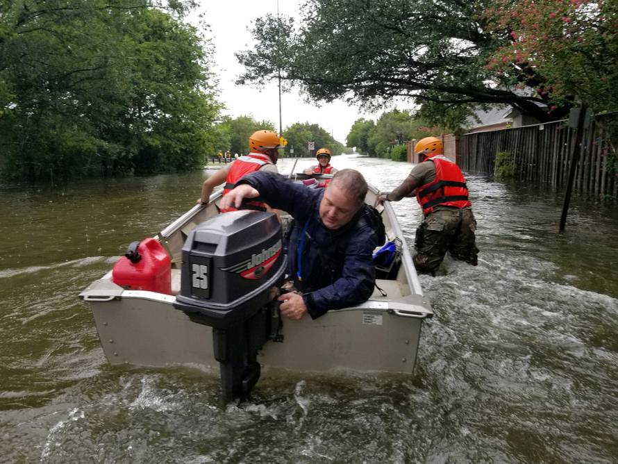 Handout photo of Texas National Guard soldiers search by boat for stranded residents in heavily flooded areas from the storms of Hurricane Harvey in Houston