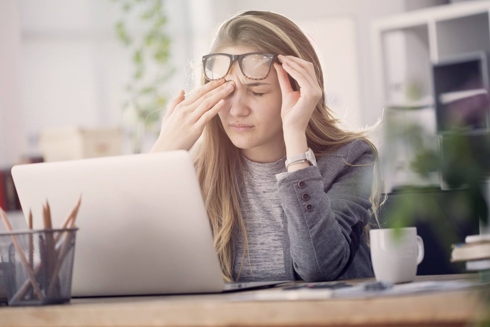 Young tired working woman at work