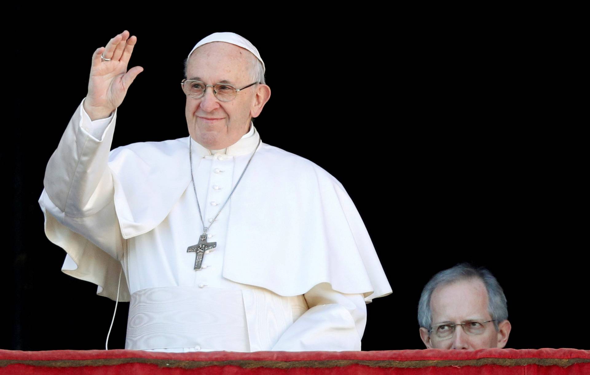 FILE PHOTO: Pope Francis waves as he arrives to deliver the "Urbi et Orbi" message from the main balcony of Saint Peter's Basilica at the Vatican