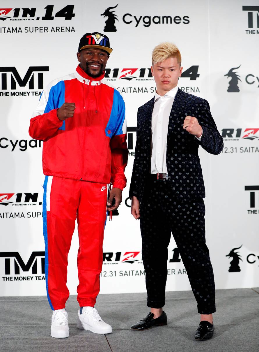 Undefeated boxer Floyd Mayweather Jr. of the U.S. poses for a photograph with his opponent Tenshin Nasukawa during a news conference in Tokyo